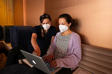 Zwei Frauen schauen auf einen Laptop