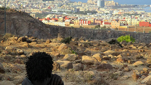 Ein Mann blickt vom Berg Gururu auf die Grenze zwischen Marokko und der spanischen Exklave Melilla