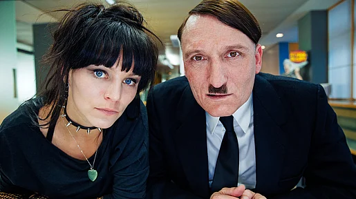 Szenenbild: Hitler und eine junge Dame schauen den Betrachter an