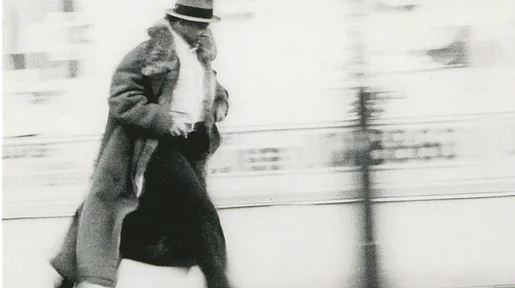 Szenenbild: Beuys von links nach rechts laufend, im wehenden Mantel
