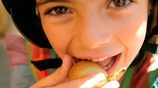 Szenenbild: Ein kleiner Junge isst Obst